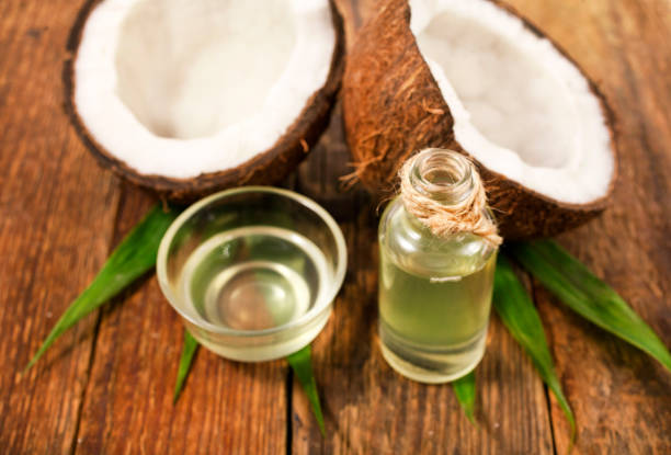 istock Coconut with coconut oil. 1053940298