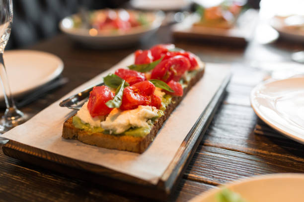 istock bruschetta with tomatos served on wooden stand 1053940876