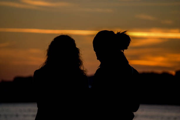 istock Young women looking at sunset 1053941160