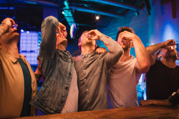 group of men taking shots - shot glass glass alcohol color image imagens e fotografias de stock