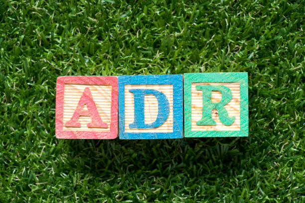 istock Color wood block in word ADR (Abbreviation of adverse drug reaction) on artificial green grass background 1053945556