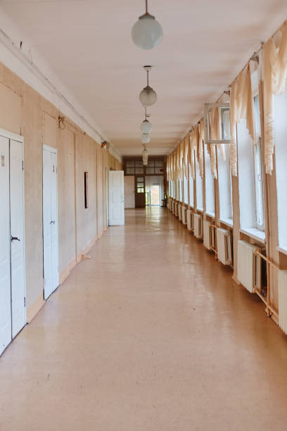 istock Vintage corridor inside the school building. With cast iron batteries and wooden window frames 1053946584
