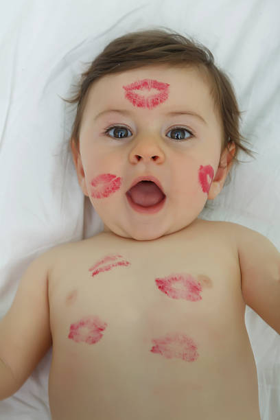 istock Baby with imprints of lipstick 1053950396