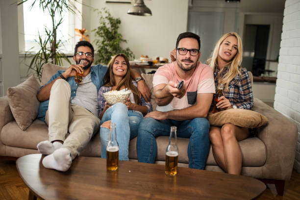 istock Friends drinking beer and watching movie 1053952378