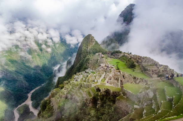 istock Cloudy morning at Machu Picchu´s starting point in Peru with tourists walking on it 1053952728