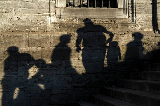 istock Shadows Of The People On Stone Wall 1053953736