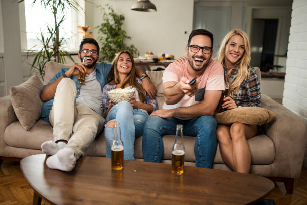 istock Friends drinking beer and watching movie 1053955048