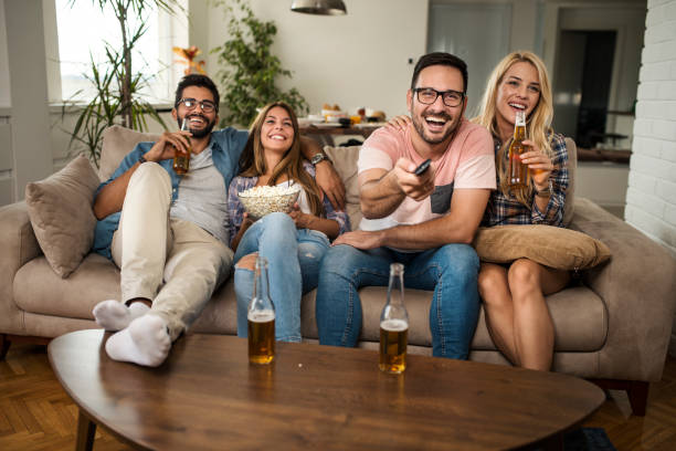 istock Friends drinking beer and watching movie 1053958570