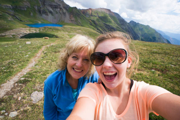 Selfie picture at Ice Lakes Mother and teenage daughter take a selfie picture from a high vantage point above Ice Lake in the Ice Lakes upper basin, 12,600 ft, Silverton, Colorado, USA colorado photos stock pictures, royalty-free photos & images