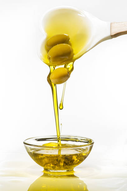 istock green olives and extra virgin olive oil with splash 1053960960