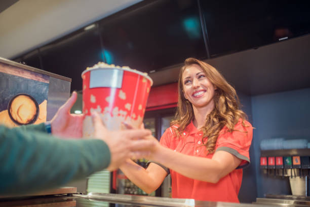 istock Smiling woman holding popcorn box 1053962202