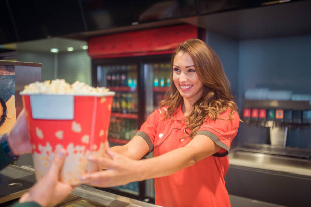 istock Smiling woman serving popcorn 1053962296