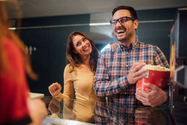 istock Happy couple holding popcorn bucket 1053963688