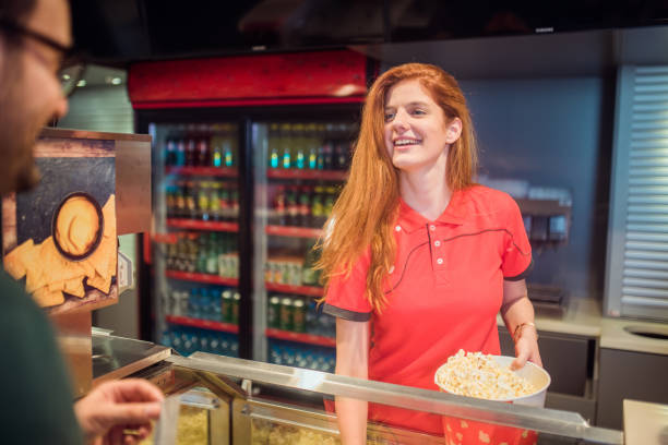 istock Redhead girl serving popcorn 1053963698