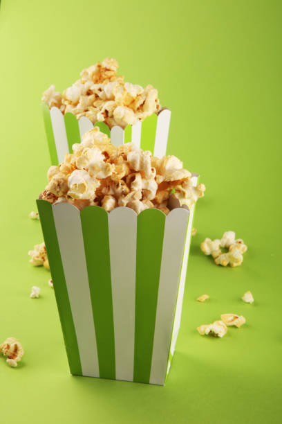 istock Cinema concept with popcorn in green white bag. 1053966358