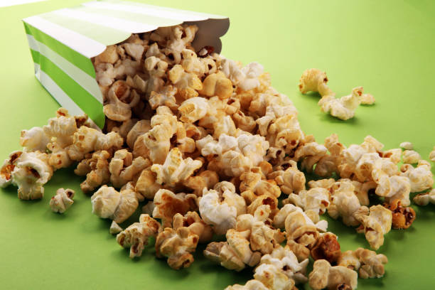 Cinema concept with popcorn in green white bag.