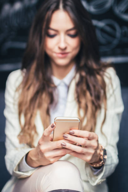 istock Beautiful  girl sitting at the table  and using a mobile phone. 1053966624
