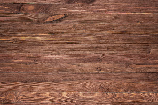 istock ustic plank wood floorboard backdrop with vignette 1053969436