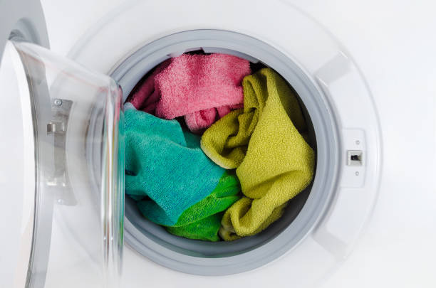 istock washing machine with color towels, clothes, open 1053969962