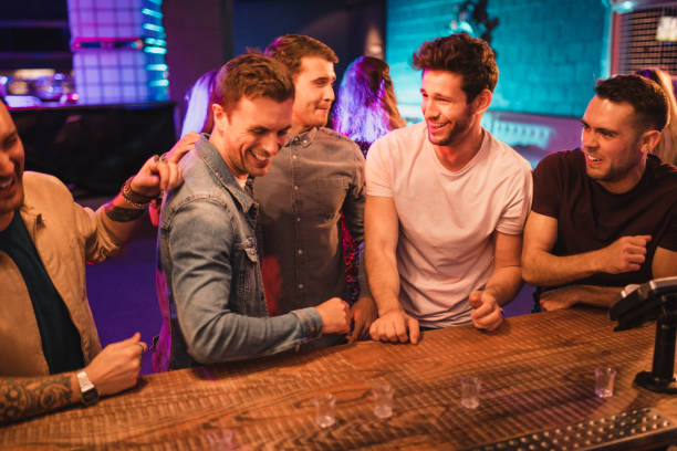 istock Male Friends Pulling Funny Faces after Taking a Shot 1053970424