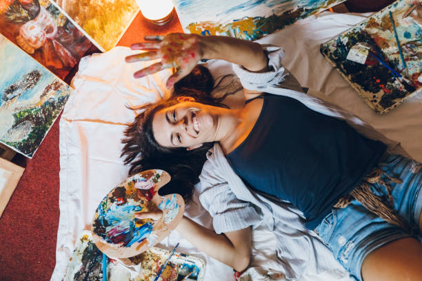 istock Woman painter surrounded with her art 1053972488