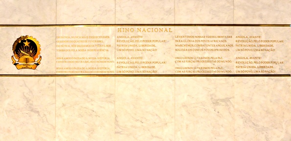 Luanda, Angola: the national anthem of Angola and the coat of arms engraved in stone - part of the unknown soldier memorial - Largo dos Correios (Post Office Square) aka Largo Pedro Alexandrino da Cunha