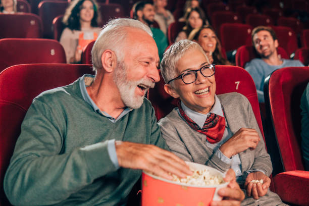 istock Smiling couple with popcorn in cinema 1053975680