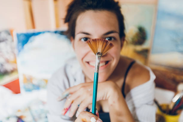 istock Woman painter surrounded with her art 1053977704