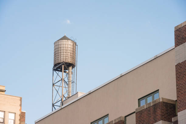istock Water Tower on Urban Manhattan Building in NYC 1053977718