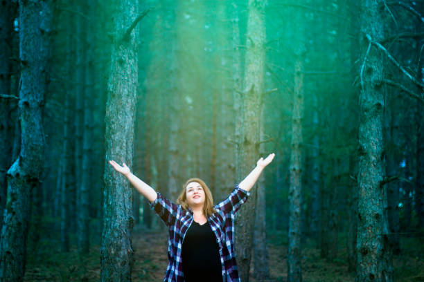 istock Young woman enjoying woods 1053977784