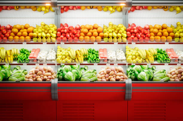 fresh vegetables & fruits in a refrigerated showcase - orange wall imagens e fotografias de stock