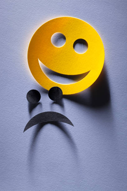 istock Happy and sad emoji faces (or comedy and tragedy theater mask) 1053979778