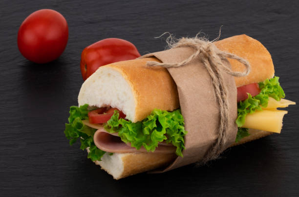 istock sandwich with with ham, cheese, tomatoes, lettuce on over stone 1053979856