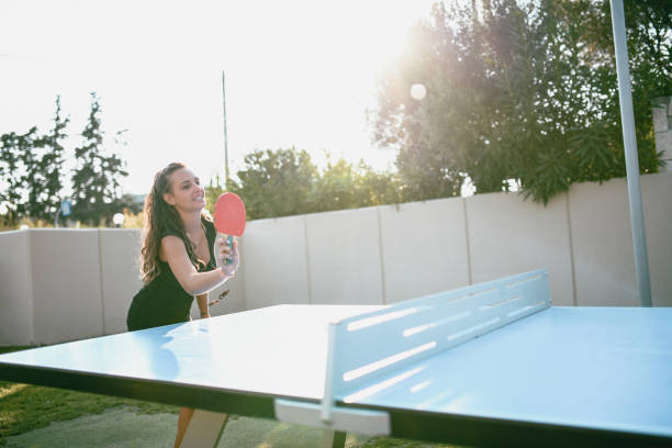 istock Cute Girl Is Playing Table Tennis In Her Front Yard 1053984758