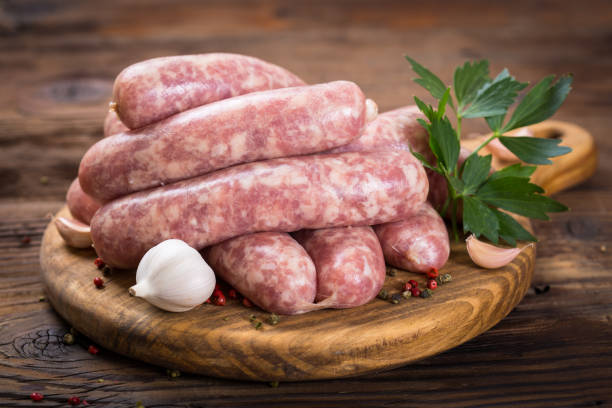 istock Raw sausages on the wooden board 1053985460
