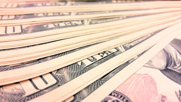 istock background ten dollar bills on the table close-up 1053986962