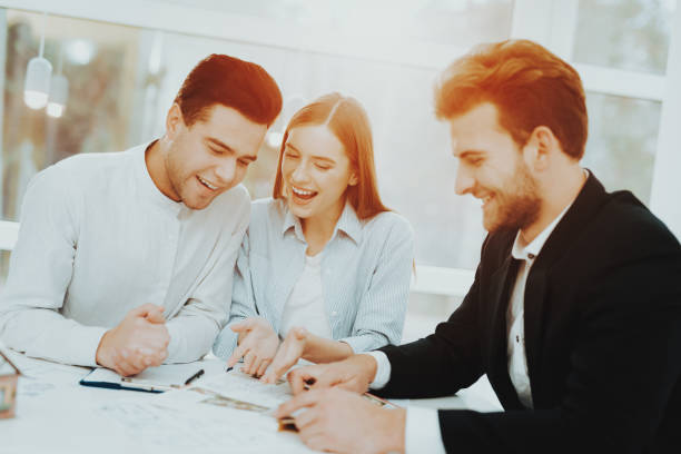 istock Young Couple Meeting With Rieltor. Bright Office. 1053987046