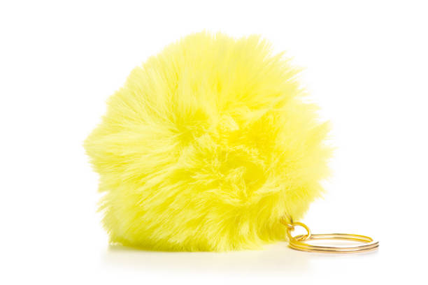 istock Fur ball yellow trinket in hand 1053994570
