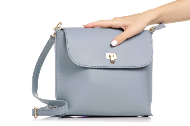 istock Female blue gray leather handbag in hand 1053994726