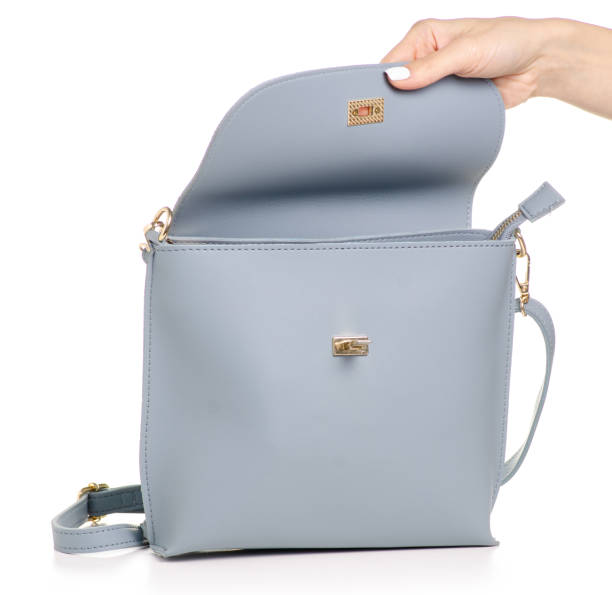 istock Female blue gray leather handbag in hand 1053994730