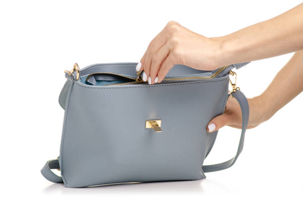 istock Female blue gray leather handbag in hand 1053994742
