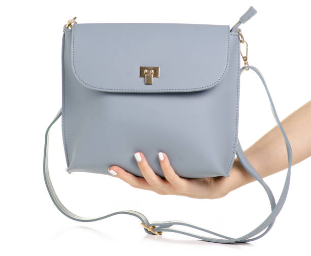 istock Female blue gray leather handbag in hand 1053994752