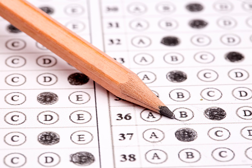 Standardized test form with answers bubbled in and a pencil