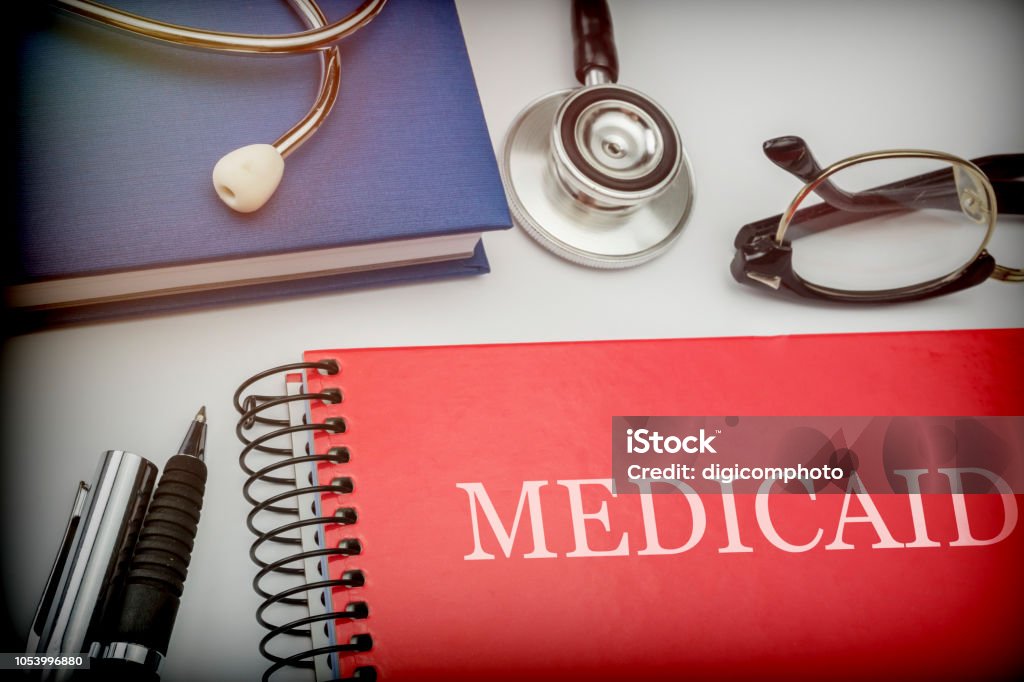 Titled red book medicaid along with medical equipment, conceptual image Medicaid Stock Photo