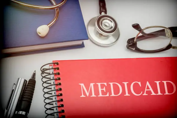 Photo of Titled red book medicaid along with medical equipment, conceptual image