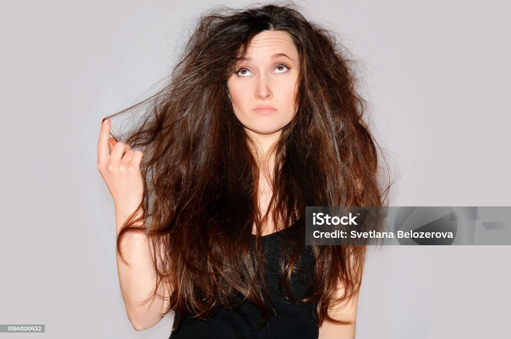 Health And Beauty Young Woman Looking At Split Ends Hair Tips Splits  Damaged Hair Long Closeup Portrait On Gray Background Stock Photo -  Download Image Now - iStock