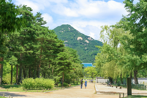 Gyeongbokgung Palace (also known as Gyeongbok Palace), was built in 1395 as the main royal palace of the Joseon dynasty. It is located in northern Seoul, South Korea. Sightseeing tourists are in the image.
