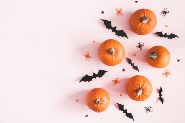 istock Halloween decorations on pastel pink background. Halloween concept. Flat lay, top view, copy space 1054003668