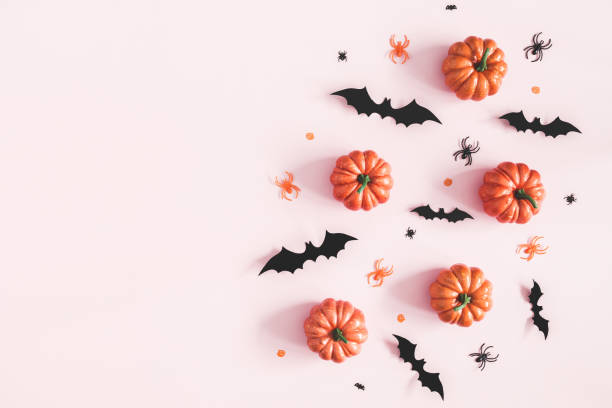 istock Halloween decorations on pastel pink background. Halloween concept. Flat lay, top view, copy space 1054003670