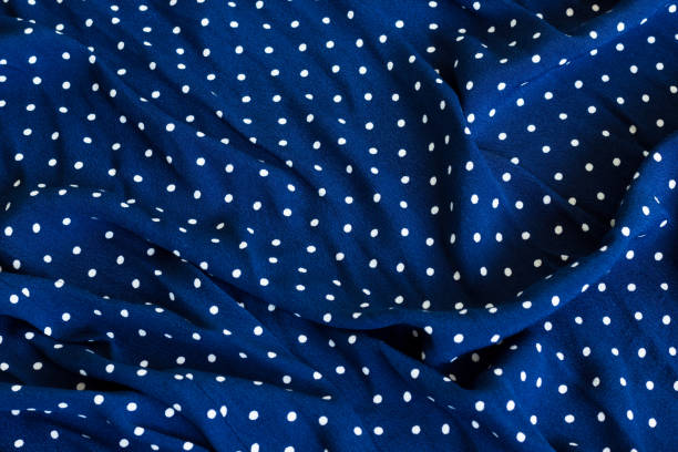 istock Dark blue wrinkled fabric with white dots 1054004144